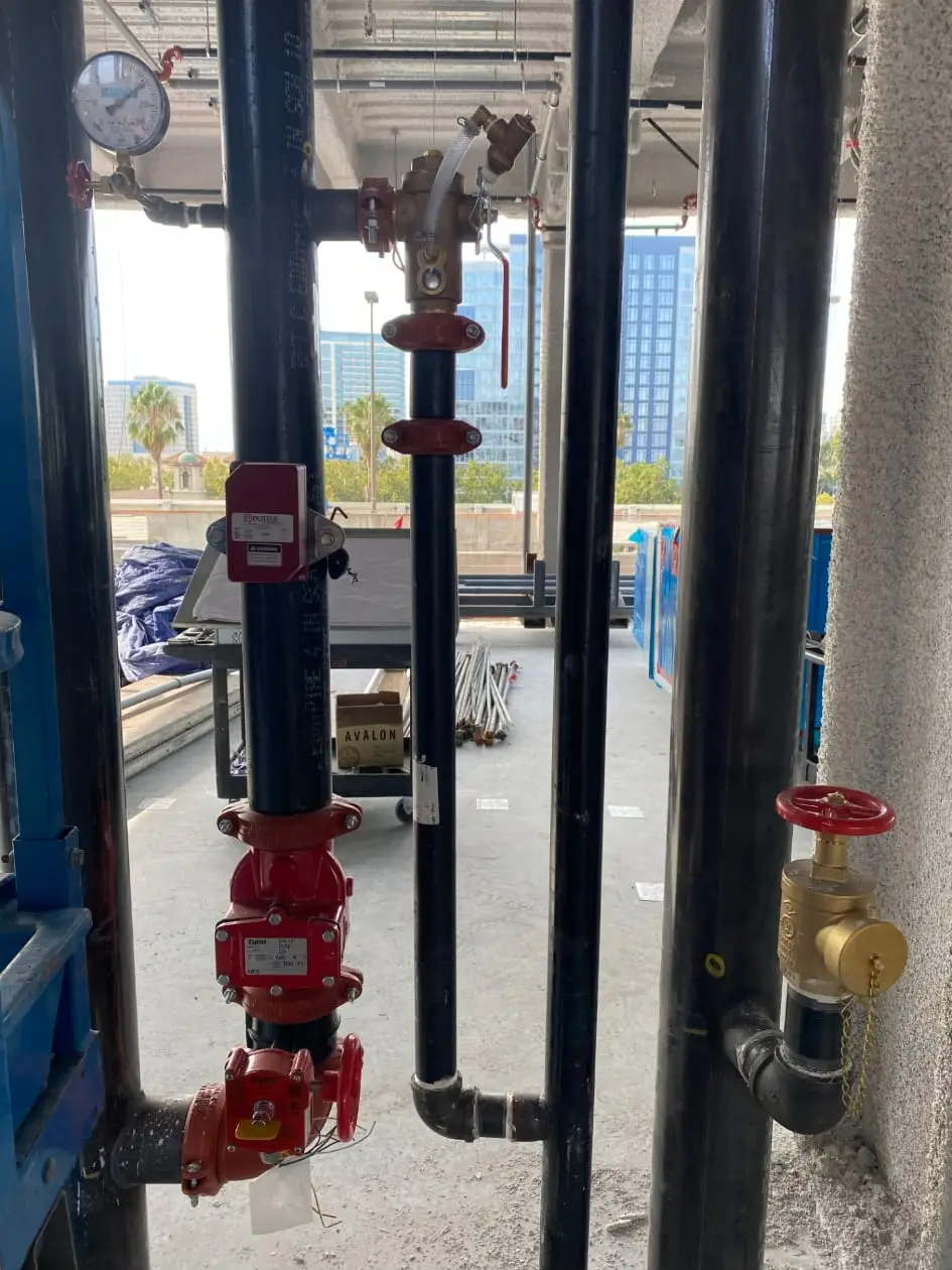 Fire sprinkler riser with pressure gauge, control valve, tamper switch and an inspection tag